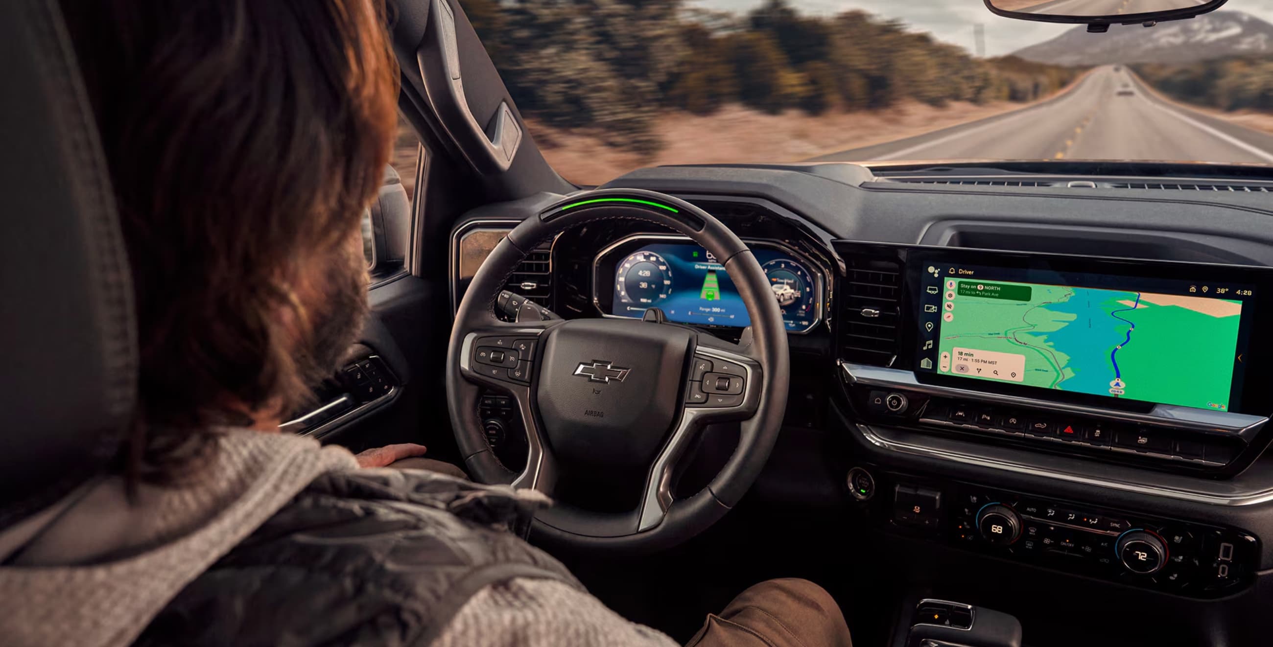 Driver's view of the 2026 Chevrolet Silverado 1500 cockpit showing the steering wheel, 12.3-inch digital driver display, and 13.4-inch touchscreen