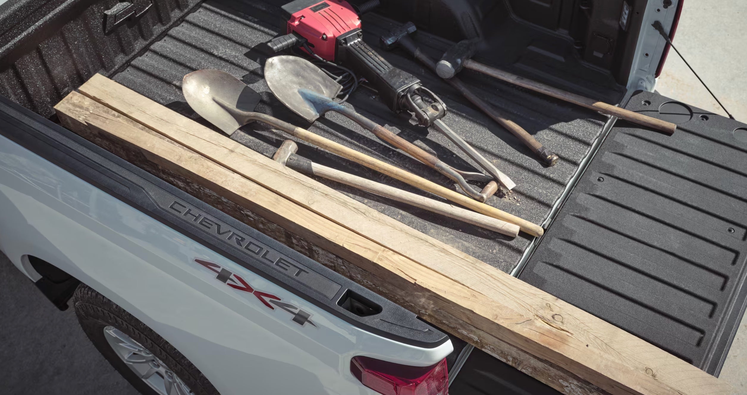 Open cargo box of the 2026 Chevrolet Silverado 1500 showing the Durabed floor, tie-downs, and tailgate down