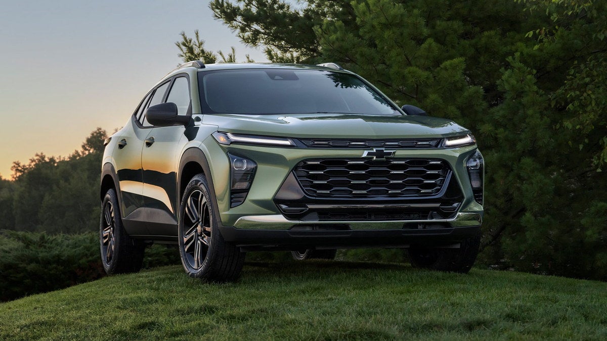 2026 Chevrolet Trax ACTIV with its unique grille and black-painted 18-inch wheels parked on grass at sunset