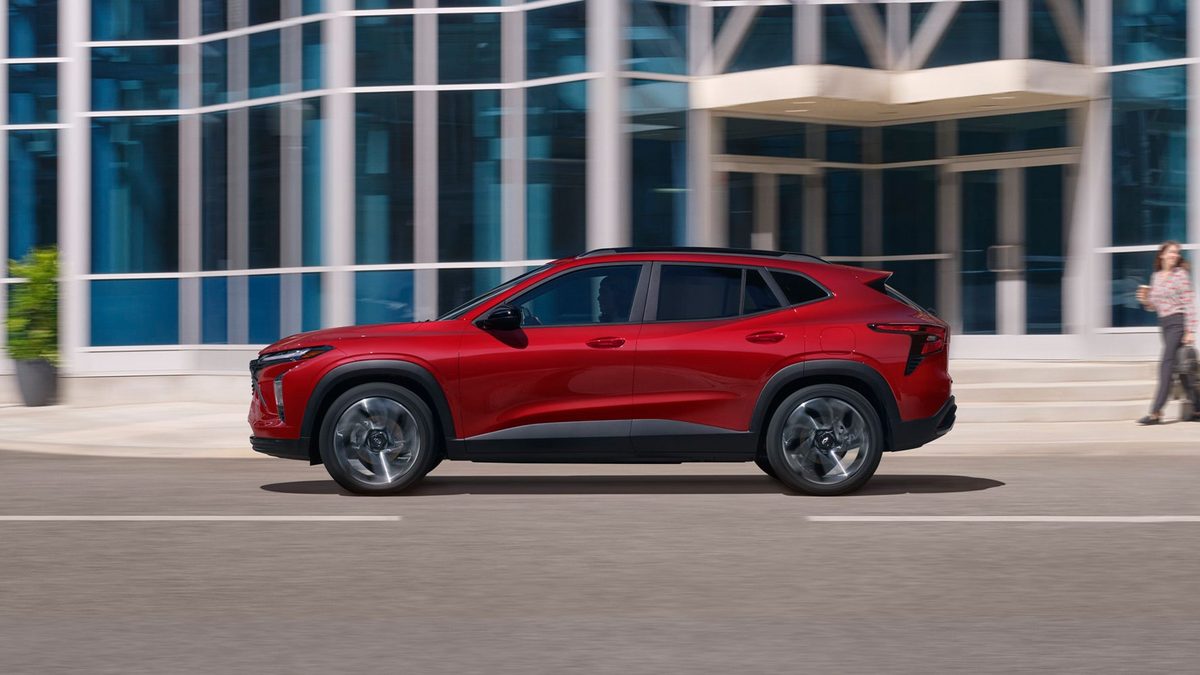 Red 2026 Chevrolet Trax RS side profile outside a modern building