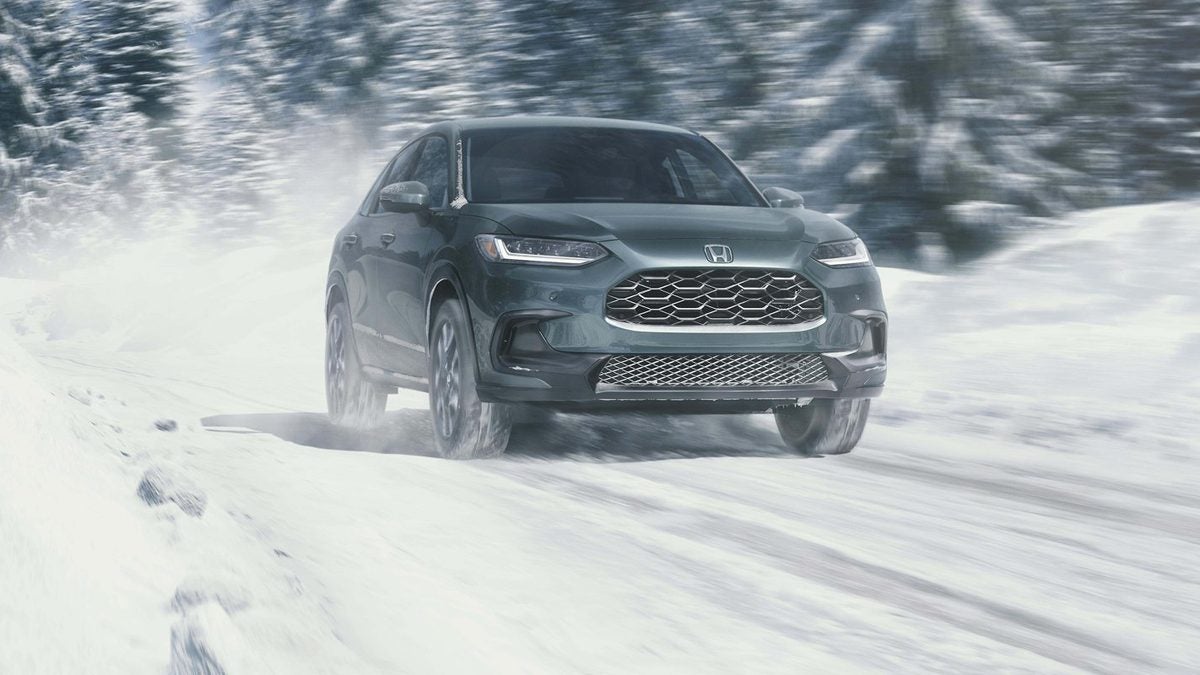 Honda HR-V EX-L in Nordic Forest Pearl driving on a snow-covered road